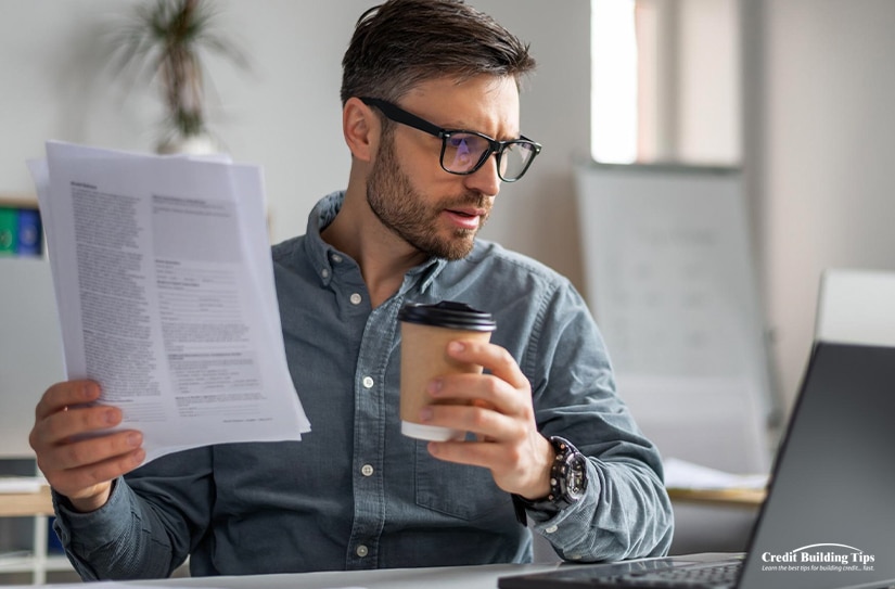 Man Looking Over Credit Report