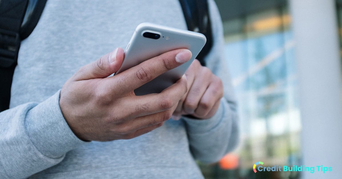 man holding cellphone purchased with bad credit