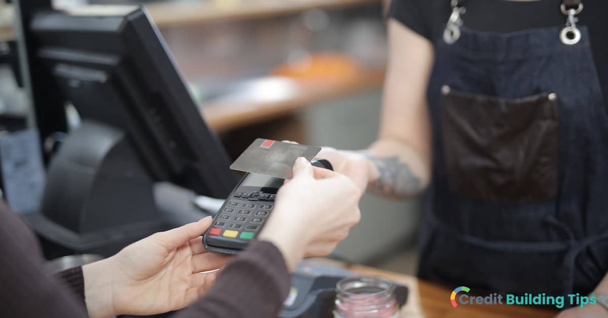 person paying with credit instead of cash at a store