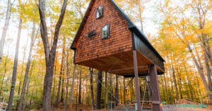 exterior of cabin in woods airbnb rental charged on credit card